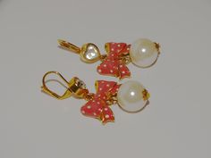 "The earrings are gold-tone metal featuring a pink bow and one large faux pearl, size 2 1/2\" inch long x 1\" inch wide, pearl size 15mm in excellent condition." Elegant Gold Jewelry With Pink Bow, Gold Dangle Jewelry With Bow, Dangle Bow Earrings, Gold Pearl Charm Clip-on Earrings, Cute Gold Bow Earrings, Pink Pearl Charm Drop Earrings, Faux Pearl Earrings, Swarovski Crystal Bracelet, Lucky Star