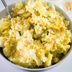 a white bowl filled with mashed potatoes on top of a table