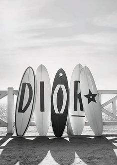 four surfboards are lined up in front of each other with the word pier written on them