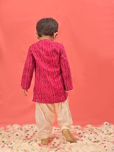 VASTRAMAY SISHU Boys' Pink Bandhni Kurta And Patiala Set Dress your little one in style and tradition with this vibrant pink kurta patiala set. Featuring a beautiful bandhani print, the kurta boasts a comfortable relaxed fit and a mandarin collar. The set comes complete with cream colored patiala pants for a complete and festive look. Key Features Pink Bandhni Print Mandarin Collar Kurta Relaxed Fit Cream Patiala Pants Elasticated Waistband for Comfort Specifications Material: Kurta - Rayon, Pat Pink Salwar Kameez For Diwali, Pink Dabka Sets For Festivals, Pink Bollywood Style Kurta For Festivals, Pink Sets With Dori Work For Transitional Season, Pink Long Sleeve Sets For Diwali, Transitional Pink Sets With Dori Work, Pink Straight Kurta Sherwani For Festivals, Festive Pink Sherwani For Puja, Traditional Pink Sherwani With Gota Work