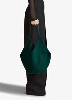 A scarf-inspired tote designed to be especially lightweight, with rounded base for stability. Includes removable leather pouch and dust bag. Designer Green Shoulder Bag With Large Capacity, Luxury Green Top Handle Bucket Bag, Elegant Green Top Handle Bucket Bag, Green Bucket Bag With Detachable Handle, Designer Green Bucket Bag With Top Handle, Luxury Green Bucket Bag For Daily Use, Designer Green Rectangular Bucket Bag, Designer Green Shoulder Bag For On-the-go, Designer Green Shoulder Bag For Everyday