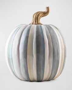 a striped ceramic pumpkin sitting on top of a table