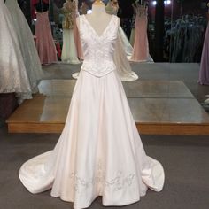 a white wedding dress on display in a store