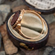 This antique ring features a fancy bezel set tigers-eye cameo with the monogram "MBG" on the underside of the ring. It is tests 10k yellow gold and is currently a size 6.5. Victorian 14k Gold Intaglio Engraved Ring, Victorian 14k Gold Signet Ring With Intaglio, Antique Signet Ring With Bezel Setting For Formal Occasions, Antique Bezel Set Signet Ring For Formal Occasions, Antique 14k Gold Signet Ring With Cabochon, Antique Oval Cabochon Ring With Bezel Setting, Antique Bezel Set Oval Cabochon Ring, Antique Collectible Round Signet Ring, Victorian Brown Collectible Jewelry