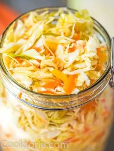 a glass jar filled with coleslaw and carrots