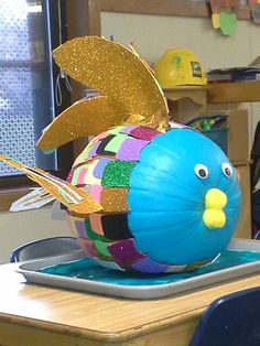 a colorful fish sculpture sitting on top of a desk