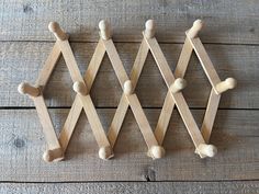 three wooden pegs are lined up on the floor