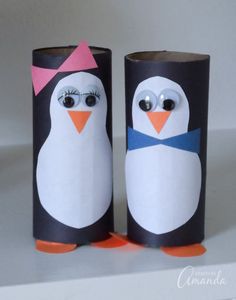 two penguins made out of toilet paper with googly eyes