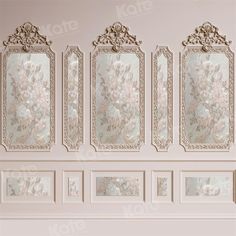 a wall with four mirrors and flowers on it