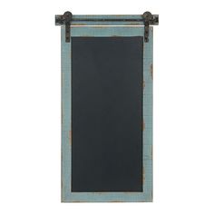 a chalkboard hanging on the side of a wall with an iron frame and metal fittings