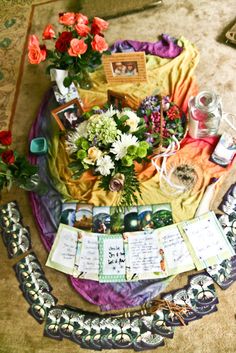 an arrangement of flowers and cards on a table