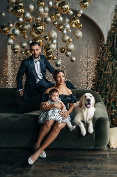 a man and woman sitting on a couch with a dog