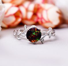 Gemstone: Black Opal  Shape/Size: Rare Round 6MM Finish Type: White rhodium/ yellow gold plating/rose gold plating / Solid14K Gold also available Ring Size: US Ring sizes 3-12  Metal Type: 925 Sterling Silver / Solid14KGold Black Fire Opal Ring Opal Engagement Ring Art Deco Twig Ring Branch Leaf Ring Black Stone Ring Gifts For Bridal Black Opal Diamond Jewelry Black Opal offers complete protection of one's emotional body and aura. This crystal provides one with an etheric shield against negative Luxury Black Opal Ring Elegant Style, Fire Opal Engagement Ring, Opal Promise Ring, Ring Black Stone, Black Fire Opal, Black Opal Ring, Black Stone Ring, Twig Ring, Engagement Ring Art Deco