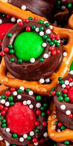 some very pretty decorated cookies with green and red frosting on them in the shape of pretzels