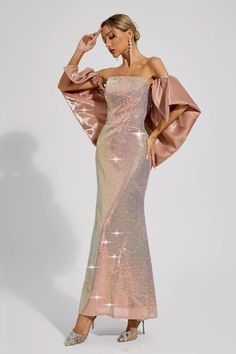 a woman wearing a pink dress with sequins