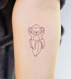 a small monkey tattoo on the arm