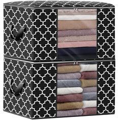 two black and white storage boxes filled with folded towels