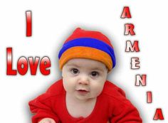 a baby wearing a red sweater and blue hat with the words i love vermont on it