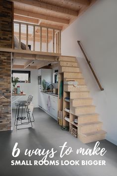 an open loft with stairs leading up to the kitchen