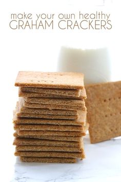 a stack of graham crackers next to a glass of milk