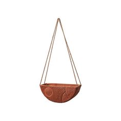 a hanging planter made out of wood and rope with a circular design on the front