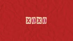 the word xoxo is written on red paper