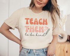 Spread a little kindness with this encouraging shirt for your classroom. Whether you are purchasing this cute teacher shirt for yourself or others, this super soft shirt is sure to become a staple in any teacher's closet. All of our adult t-shirts are unisex jersey short sleeve tees. The combed and ring-spun cotton leaves this shirt feeling extremely soft and lightweight. Its flexible and breathable material is perfect for casual wear.  Product Information: Bella + Canvas 3001 Unnisex  Extremely Cute T-shirt For Teacher Appreciation Back To School, White Crew Neck T-shirt For Teacher Appreciation, Cotton T-shirt For Teaching, Back To School, Custom Print Crew Neck T-shirt For Teacher Appreciation, Graphic Print Short Sleeve T-shirt For Teacher Appreciation, Teaching Shirts, Teachers Diy, Kindness Shirts, Teacher Tees