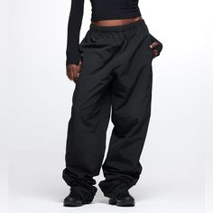 New With Tags Thirtyyears Black Track Pants. Size Small With 36” Inseam. Track-Style Pants Made Of 100% Nylon, Featuring An Interior Drawcord Toggle, Two Side Seam Pockets + One Cargo-Style Back Pocket And Elastic Zip Cuffs. 100% Nylon/100% Polyester Lining Elastic Waist With Interior Drawcord Toggle Elastic Zip Cuffs Two Side Seam Pockets, One Back Pocket Fabric Care: For Best Results, Machine Wash Cold And Hang Dry. Do Not Iron Or Dry Clean. Fit: True To Size. Streetwear Parachute Pants With Elastic Waistband, High Waist Nylon Sports Pants, Winter Streetwear High-waisted Pants, High-waisted Parachute Pants With Elastic Waistband For Streetwear, High Waist Nylon Sportswear Bottoms, Sporty High-waisted Pants With Cargo Pockets, Black Wide Leg Sportswear Pants, Straight Parachute Pants With Elastic Waistband For Streetwear, Full-length Sportswear Pants For Streetwear