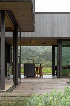 an outdoor dining area with wooden flooring and sliding glass doors