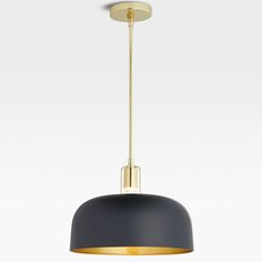 a black and gold pendant light hanging from the ceiling