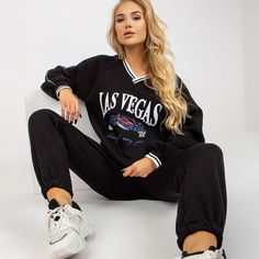 Bring style to your workout or casual days with our Las Vegas Black Sports Tracksuit Set. This dynamic ensemble includes a sweatshirt designed with long sleeves and a heart neckline, adding a touch of flair to your athletic or leisure wardrobe. Paired with comfortable long pants featuring a waist tie and convenient slip pockets, this tracksuit set effortlessly combines fashion and functionality. Crafted from a premium blend of 70% cotton and 30% polyester, it ensures both comfort and durability. Trendy V-neck Sweatshirt For Loungewear, Trendy Long Sleeve Sweatshirt For Sports, Trendy Long Sleeve Sports Sweatshirt, Sporty V-neck Sweatshirt With Ribbed Cuffs, Oversized Sporty V-neck Sweatshirt, Oversized Sporty Sweatshirt With V-neck, Sporty V-neck Sweatshirt For Streetwear, Trendy Long Sleeve Sweats For Sports, Casual Long Sleeve Tracksuit For Workout