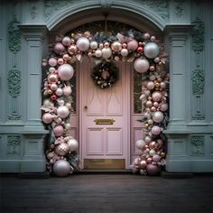 a pink door decorated with ornaments and wreaths