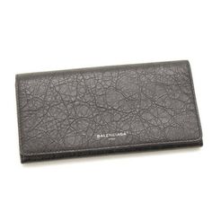 This classic Balenciaga wallet is meticulously crafted of pebbled grey calfskin leather with a Balenciaga logo on the front face. The interior is made with the same leather and features twelve card slots, two bill slots, and one interior zipper compartment. The sleek and functional design of this wallet works perfectly for everyday use. Model number: 542008 Antracite grey Crinkled leather Balenciaga logo Fold-over flap with snap closure Twelve card slots Two bill slots One interior zipper compar Designer Formal Wallet In Textured Leather, Designer Formal Wallets With Embossed Logo, Formal Leather Wallets With Embossed Logo, Designer Wallets With Embossed Logo For Business, Designer Business Wallets With Embossed Logo, Formal Bifold Wallet With Embossed Logo, Rectangular Leather Wallet With Pebbled Texture, Leather Bifold Wallet With Embossed Logo, Luxury Leather Wallet With Grained Texture