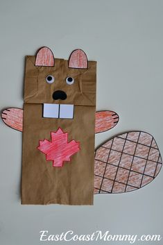 a brown paper bag with an image of a bear and maple leaf cut out on it