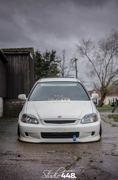 a white car parked in front of a house