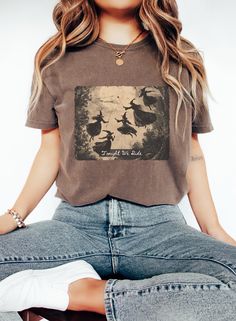 Get ready to embrace your inner witch with our "Tonight We Ride" T-shirt! Featuring a stunning vintage-inspired scene of witches flying under a full moon, this tee is perfect for those who live for spooky season and love a touch of classic witchy flair. Whether you're heading to a Halloween gathering or just want to keep the magic alive year-round, this shirt is designed to capture the thrill of midnight rides and enchanted nights. 🎃 Why You'll Love It: -High-quality print of a classic witchy scene -Soft, breathable fabric that's perfect for layering -Ideal for Halloween parties, witchy meet-ups, or as a gift for your favorite witch! -Available in multiple sizes and colors to suit your style Get yours today and join the coven--because tonight, we ride! 🌙✨ Witches Flying, Vintage Witches, Inner Witch, Halloween Lovers, Vintage Witch, Witchy Vibes, Halloween Parties, Fete Halloween, Halloween T Shirt