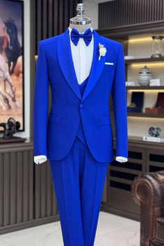 a mannequin dressed in a blue suit and bow tie