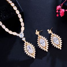 A beautiful bridal jewelry set that will add elegance and sophistication to any wedding gown or formal ensemble! Adorned with intricately faceted cubic zirconia that capture the light from every angle with a perfectly translucent appeal, the pieces are platinum / 14K yellow gold plated for a flawless finish which enhances the intricate detailing and conveys a modern take on old elegance. Necklace: 16.5" (approx. 42cm) long with a secure fold-over closure (if longer is needed, a 2" extension chai Wedding Bridal Earrings With Diamond-cut Crystal, Dazzling Diamond Cut Bridal Earrings For Wedding, Elegant Cubic Zirconia Jewelry Sets With Diamond Accents, Elegant Cubic Zirconia Jewelry Set In Diamond White, Exquisite White Cubic Zirconia Jewelry Sets, Elegant Diamond White Jewelry Set With Cubic Zirconia, White Crystal Bridal Sets With Elegant Design, Elegant Bridal Sets With Brilliant Cut For Wedding, Dazzling Cubic Zirconia Jewelry Set With Diamond Cut