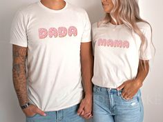 a man and woman standing next to each other with donuts on their t - shirts