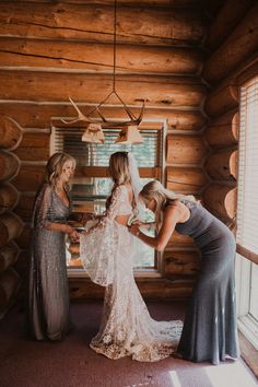 three brides getting ready for their wedding in the cabin