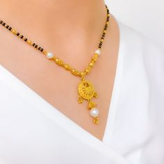 PRODUCT DETAILS Gold Purity(karat): 22k Item Weight(grams): 14.3 Item Finish: Yellow Gold Stone: Black Bead + Pearl Necklace Length: 18.5" Drop Length: 1.5" Adjustable Links: ﻿1.6" Lock Style: Hook Lock Gold Necklace With Black Beads For Puja, Traditional Black Filigree Jewelry, Black 22k Gold Jewelry As A Gift, Black 22k Gold Jewelry Gift, Festive Black Necklace In 22k Gold, Black 22k Gold Jewelry For Wedding, Black 22k Gold Wedding Jewelry, Elegant Black Beaded Jewelry For Puja, Traditional Yellow Gold Jewelry With Black Beads