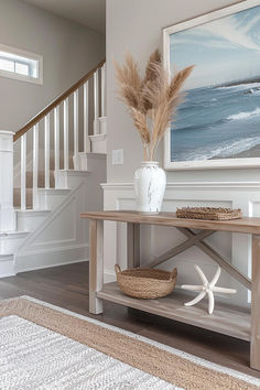 a white vase sitting on top of a wooden table in front of a stairway case