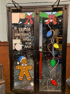 two glass doors with christmas decorations on them