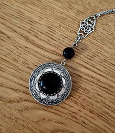 This spectacular locket features a natural onyx gem as a focal. The stone is nestled in layers of intricate filigree, which were made in USA using vintage tools and dies. The locket is attached to a natural onyx bead. Another filigree component is connecting the pendant to the chain. The drop of the locket 70mm. The stainless steel beaded satellite chain is 45cm long finished with a lobster claw claps. Pool Wear, Victorian Locket, Prayer Box, Vintage Tools, Onyx Bead, Locket Necklace, Victorian Style, Stainless Steel Chain, Black Beads