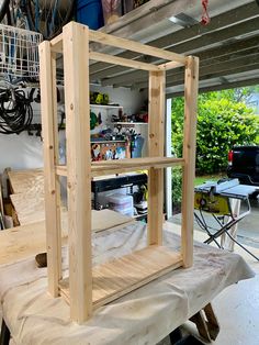 an unfinished shelf sitting on top of a piece of wood