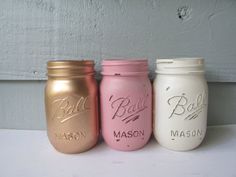 three different colored mason jars sitting next to each other