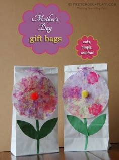 mother's day gift bags made out of paper and tissue paper with flowers on them