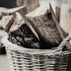 a basket filled with logs sitting on top of a table