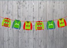 an image of christmas sweaters on a line with clothes hanging from the line in front