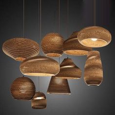 a group of wooden lights hanging from the ceiling in a dark room with dim lighting